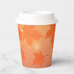 Autumn design with maple leaves and bokeh effect paper cups