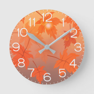 Autumn design with maple leaves and bokeh effect round clock