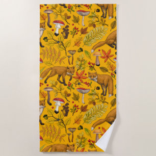 Autumn foxes on orange beach towel