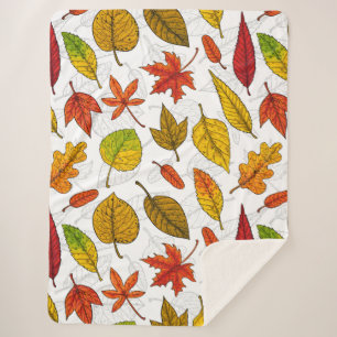 Autumn leaves on white sherpa blanket