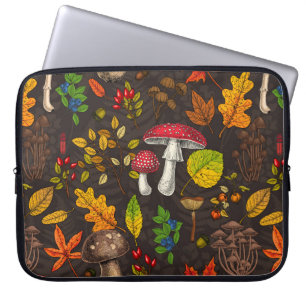 Autumn mushrooms, leaves, nuts and berries on blue laptop sleeve