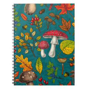 Autumn mushrooms, leaves, nuts and berries on blue notebook