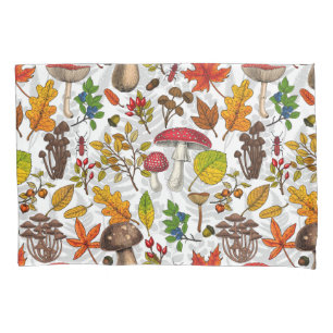 Autumn mushrooms, leaves, nuts and berries on blue pillowcase