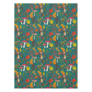 Autumn mushrooms, leaves, nuts and berries on blue tablecloth