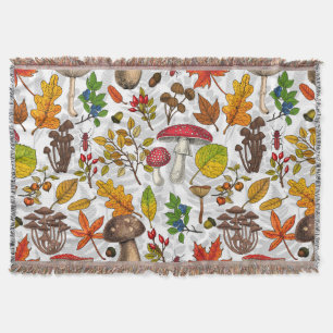 Autumn mushrooms, leaves, nuts and berries on blue throw blanket