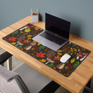 Autumn mushrooms, leaves, nuts and berries on dark desk mat