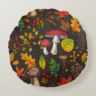 Autumn mushrooms, leaves, nuts and berries on dark round cushion
