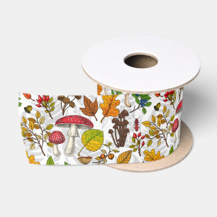 Autumn mushrooms, leaves, nuts and berries on whit satin ribbon