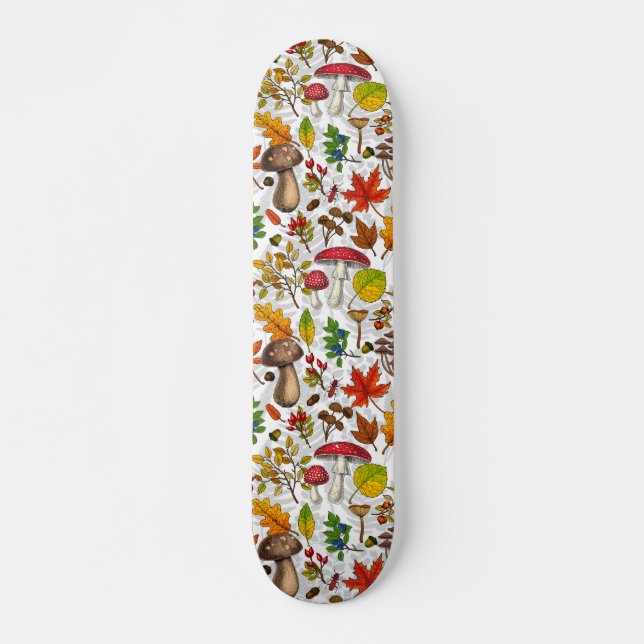 Autumn mushrooms, leaves, nuts and berries on whit skateboard (Front)