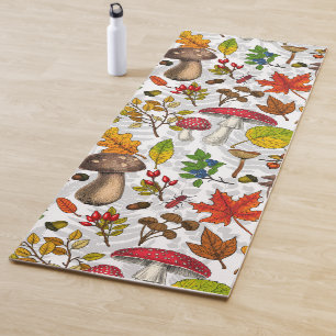 Autumn mushrooms, leaves, nuts and berries on whit yoga mat