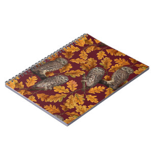 Autumn owls on dark red notebook