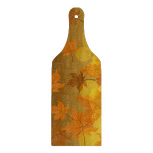 Autumn pattern with falling maple leaves and bokeh cutting board