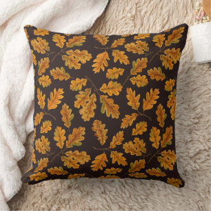 Autumnal oak leaves on dark brown cushion