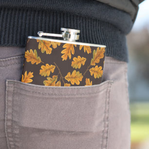 Autumnal oak leaves on dark brown hip flask