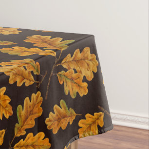 Autumnal oak leaves on dark brown tablecloth