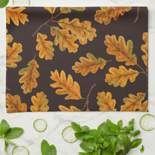 Autumnal oak leaves on dark brown tea towel