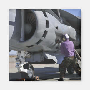 Aviation fuel technician attaches a fuel line magnet