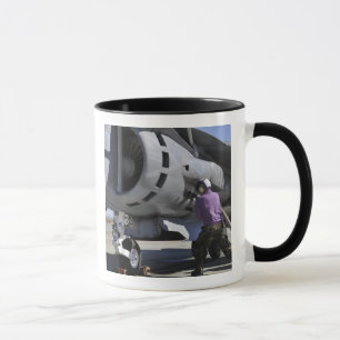 Aviation fuel technician attaches a fuel line mug