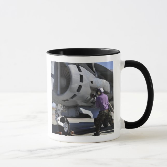 Aviation fuel technician attaches a fuel line mug (Right)