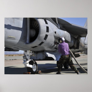 Aviation fuel technician attaches a fuel line poster