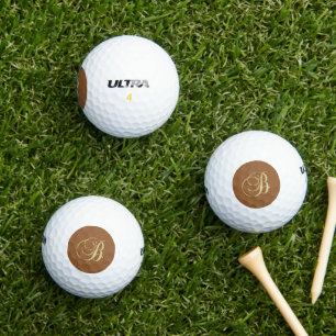 B ornate gold monogram golf balls
