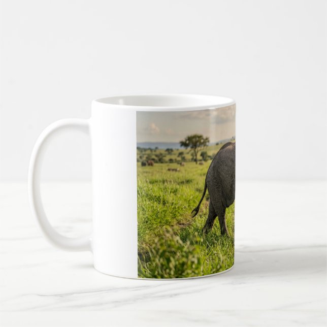 Baby Elephant Walking Through Grass Coffee Mug (Left)