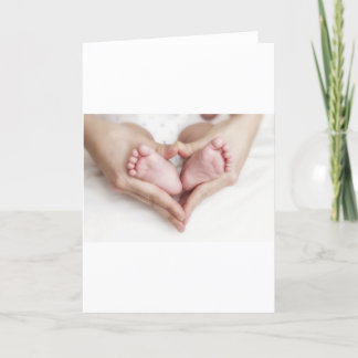 Baby feet in mother hands card
