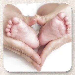 Baby feet in mother hands coaster