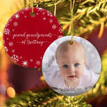 Baby Photo First Christmas Snowflakes Grandparents Ceramic Ornament<br><div class="desc">“First Christmas.” A playful visual of white snowflakes and handwritten script typography with customised year, overlaying the photo of your choice, help you usher in Christmas and New Year. On the back, additional white snowflakes and handwritten typography with “proud grandparents of baby’s name” overlay a red background. Feel the warmth...</div>