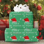 Baby`s First Christmas Green Santa Hat Snowflake Wrapping Paper<br><div class="desc">Baby`s First Christmas Green Red Santa Hat Snowflake Wrapping Paper. Cute baby first Christmas design with a Santa hat,  snowflakes and a baby name in a white script - personalise with your baby`s name.</div>