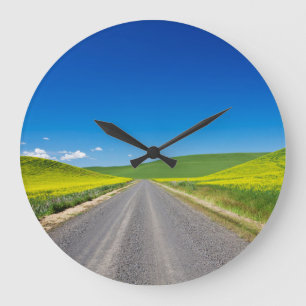 Backcountry road through Spring Canola Fields Large Clock