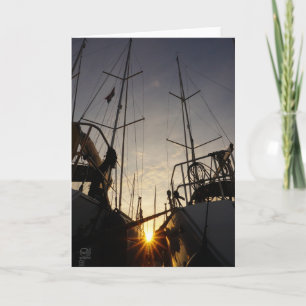 Backlight on 2 sailboats in the harbor. card