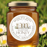 Backyard Hives Honey Label Hand Bottled Raw<br><div class="desc">Put your bees front and centre by choosing this beautiful rendition of a backyard hive. This label exudes all the characteristics of a picturesque family business, while still maintaining a strong level of sophistication with a professional touch. Simply personalise with your apiary name, address and honey description (raw, hand bottled,...</div>