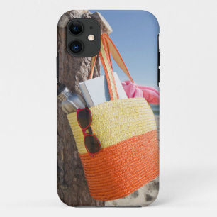 Bag Hanging On Tree Trunk At Sandy Beach iPhone 11 Case