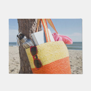Bag Hanging On Tree Trunk At Sandy Beach Doormat