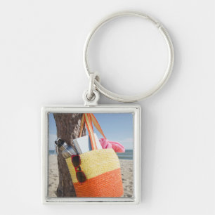 Bag Hanging On Tree Trunk At Sandy Beach Key Ring