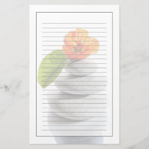 Balanced stones and red flower stationery