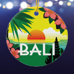 Bali Indonesia memento vintage travel style Ceramic Ornament<br><div class="desc">Bali Indonesia ornament with an original collage illustration modelled after the vintage travel style posters of the past. The brightly coloured tropical image includes a sunset over the ocean, a stylised palm tree, frangipani flowers, and a silhouette of a Balinese temple. The ornament makes a wonderful memento of a visit...</div>