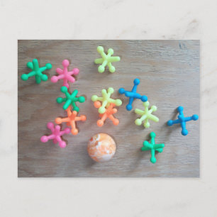 Ball with Colourful Jacks Tossed on Board  Postcard