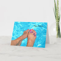 Bare feet with flowers in pool