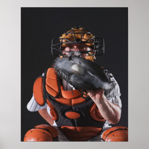 Baseball catcher holding ball in mitt poster