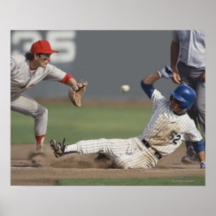 Baseball player sliding into third base with poster