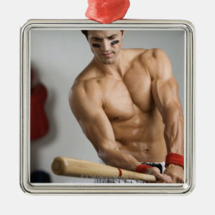Baseball player with bare chest warming up with metal ornament