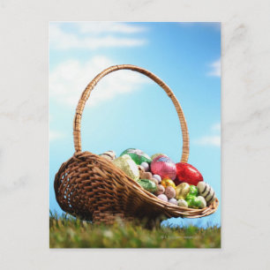 Basket filled with Easter eggs on grass, ground Holiday Postcard