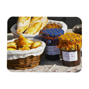 Basket with croissants and chocolate breads. magnet