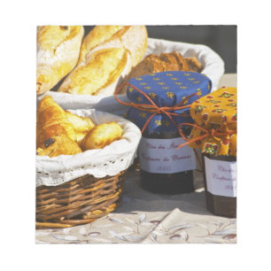 Basket with croissants and chocolate breads. notepad