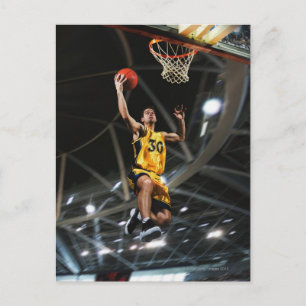 Basketball player jumping in air postcard