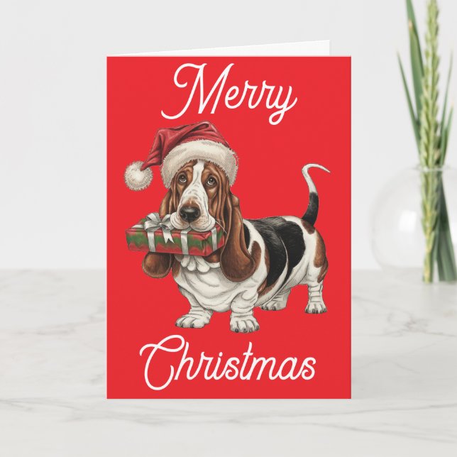 Basset Hound in Santa hat present in mouth Card (Front)