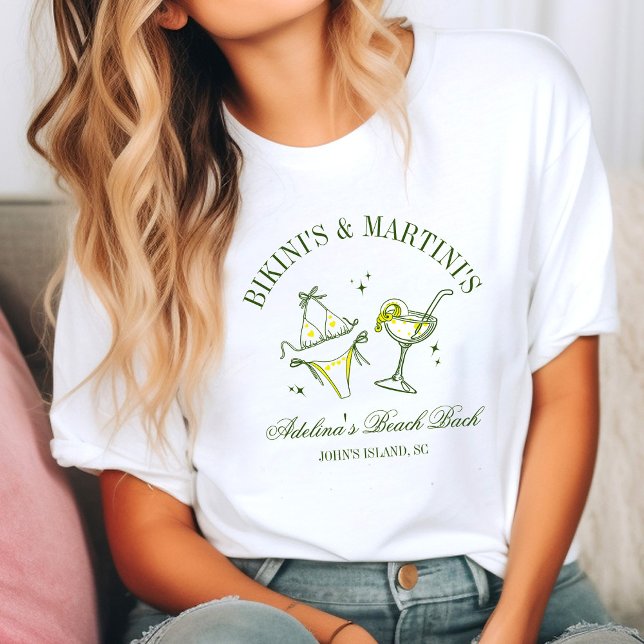 Beach Bachelorette Party Favour Social Club T-Shirt (Woman in a casual setting wearing a white T-shirt with a fun design of a bikini and martini glass. )