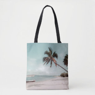 Beach beside coconut palm tree tote bag